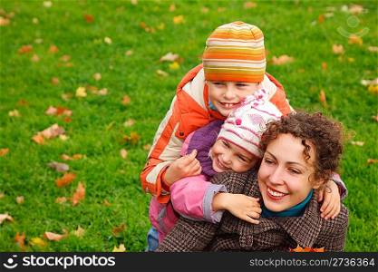 mother withdaughter andson in autumnal park