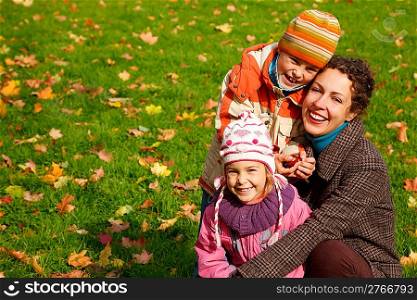 mother withdaughter andson in sunny autumnal park