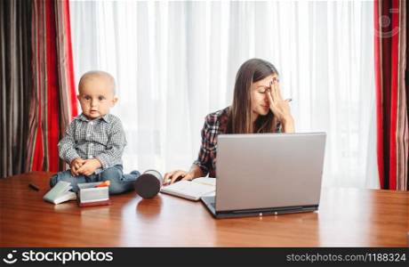 Mother works at home little kid helps her, motherhood problems. Sad mom and son together at home, parenthood