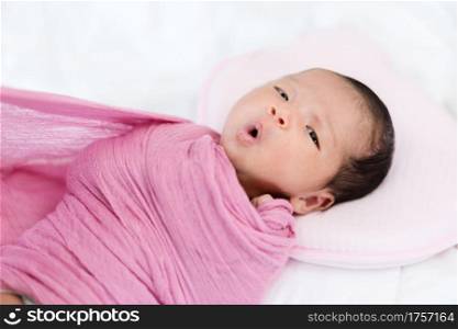 mother wrapping blanket on her baby newborn