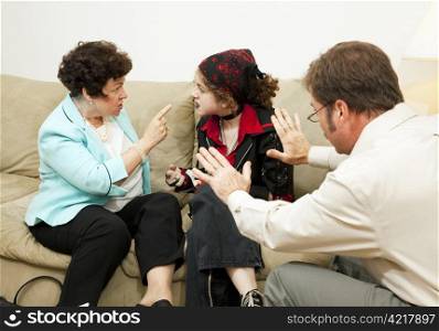 Mother yelling at her teen daughter during a family counseling session.