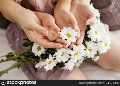 mother young girl holding bouquet spring flowers
