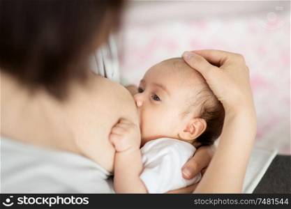 motherhood, children, people and care concept - close up of mother breastfeeding newborn baby. close up of mother breastfeeding newborn baby