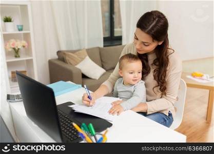 motherhood, multi-tasking, family and people concept - happy mother with baby, papers and laptop working at home. happy mother with baby and papers working at home