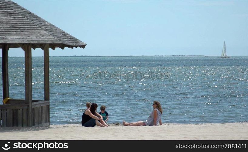 Mothers and children enjoy a beach
