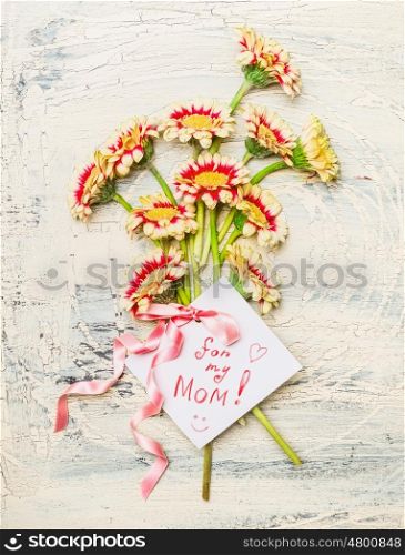 Mothers day card with Pretty flowers bunch, rose ribbon and handwritten text : for my mom on light shabby chic background, top view