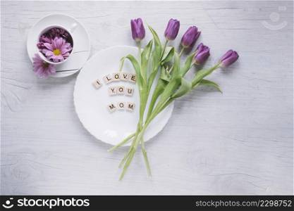 mothers day composition with purple roses plate