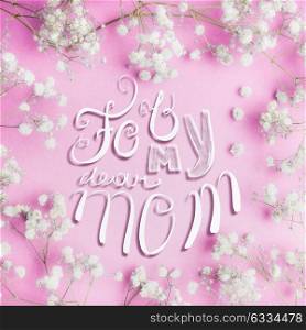 Mothers day greeting card with For my dear mom lettering and lovely little white Gypsophila flowers on pastel pink background, square