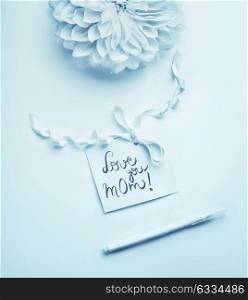Mothers day greeting card with pretty flower and Love you mom lettering card, top view
