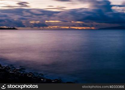Motion blur of storm clouds over sea at dusk, Maui, Hawaii