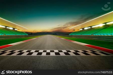 Motion blurred racetrack with start or end line . Night scene .