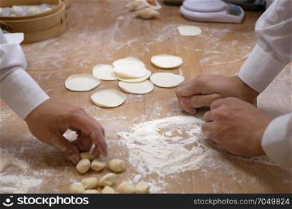 Motion of people are kneading the dough and shaping it with their hands to make dumplings in Taipei Taiwan