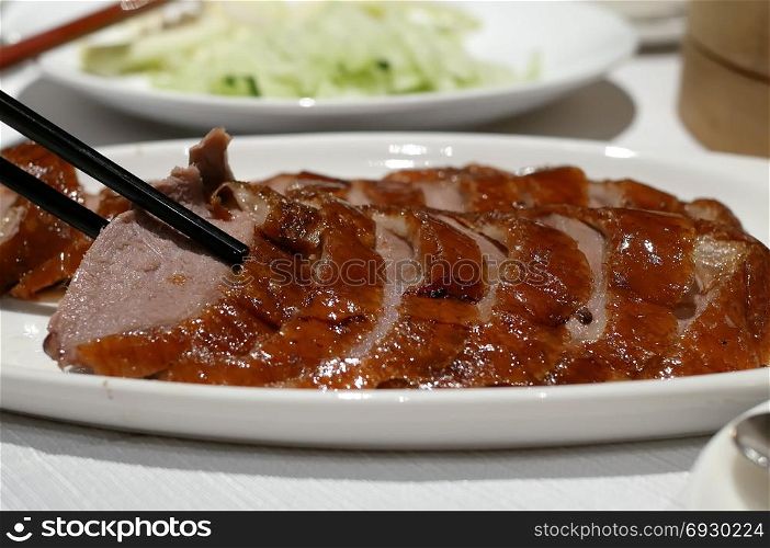 Motion of people eating roasted duck on table inside restaurant