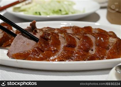 Motion of people eating roasted duck on table inside restaurant