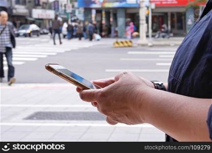 Motion of woman crossing street and using mobile phone in Taipei Taiwan