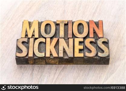 motion sickness - word abstract in vintage letterpress wood type printing blocks