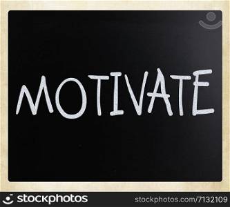 ""Motivate" handwritten with white chalk on a blackboard"