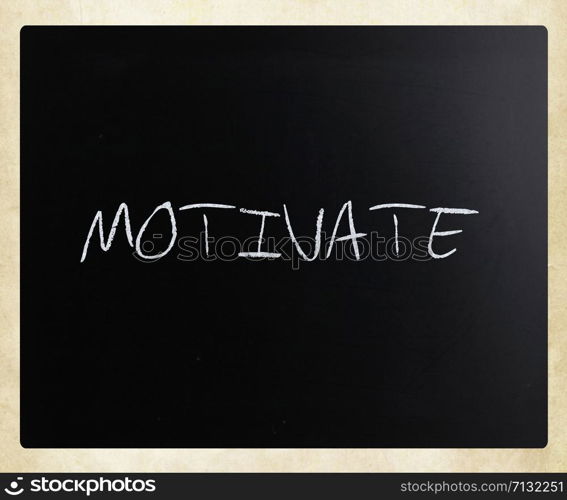 ""Motivate" handwritten with white chalk on a blackboard."