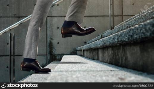 Motivation and challenging Concept. Steps Forward into a Success. Low Section of Businessman Walking Up on Staircase
