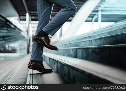 Motivation and challenging Concept. Steps Forward into a Success. Low Section of Businessman Walking Up on Staircase