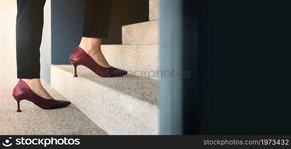 Motivation and Challenging Concepts. Woman Power. Steps Forward into a Success. Low Section of Business Woman Walking Up on Staircase