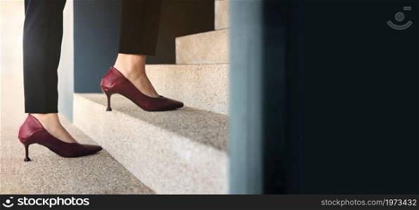 Motivation and Challenging Concepts. Woman Power. Steps Forward into a Success. Low Section of Business Woman Walking Up on Staircase
