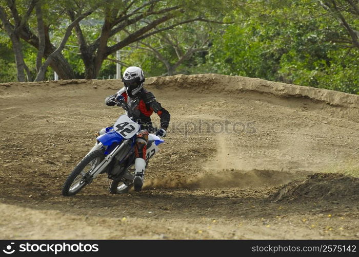 Motocross rider leaning into a turn