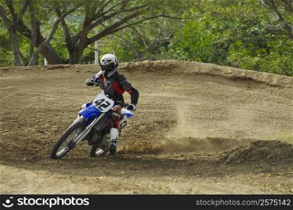 Motocross rider leaning into a turn