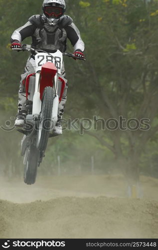 Motocross rider performing a jump on a motorcycle