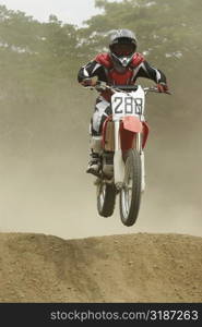 Motocross rider performing a jump on a motorcycle