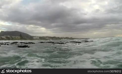 Motor boat entering rough sea on the coast of South Africa