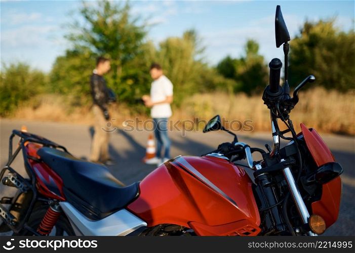 Motorbike, driving course on motordrome, motorcycle school, male student and instructor on background. Training of motorcyclists beginners, biker practicing in motorschool. Motorbike, driving course, motorcycle school