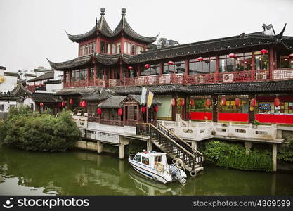 Motorboat near a building, Nanjing, Jiangsu Province, China