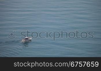 motorboat sailing along the seashore