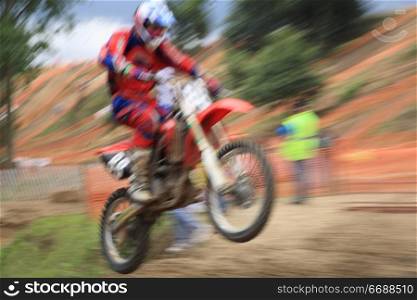 Motorcross rider, abstract image created with intentional motion blur and zooming effect.