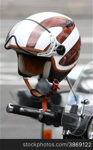 Motorcycle helmet hunging up on rearview mirror