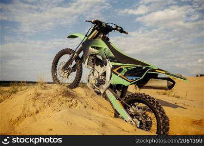Motorcycle parked in sand dune prepared for motocross racing. Iron horse for speed riding. Motorcycle parked in dune prepared for motocross
