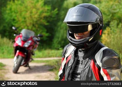 motorcyclist and his bike on country road