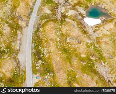 Motorhome camper car van on road trip. Norway mountains landscape. Norwegian national tourist scenic route Sognefjellet. Aerial view. Camper car in mountains on roadside, Norway