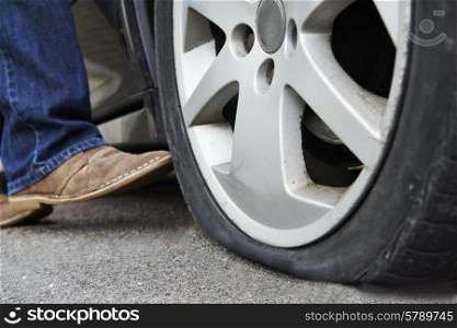 Motorist Kicking Flat Tyre On Car