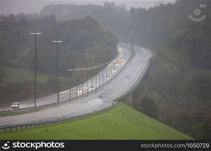 motorway traffic during rain in autumn on e42 in belgium
