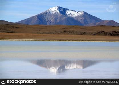 Mount and reflection in the salt lake near Yuni in Bolivia