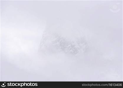 Mount Burgess in Yoho National Park nearly completely shrouded by clouds early one morning.