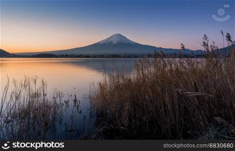 mount Fuji at dawn with peaceful lake