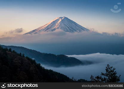 Mount Fuji enshrouded in clouds with clear sky from lake kawaguchi, Yamanashi, Japan