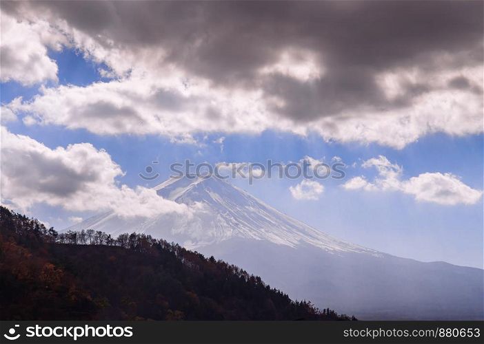 Mount Fuji silhouette behind hills and clouds in Kawaguchiko peaceful cold winter. Fujikawaguchiko - Japan