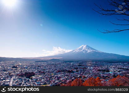 Mount Fuji with snow and blue sky sun flare, colourful autumn tree with Shimoyoshida city seen from Chureito Pagoda Arakurayama Sengen Park in Fujiyoshida near Kawaguchigo