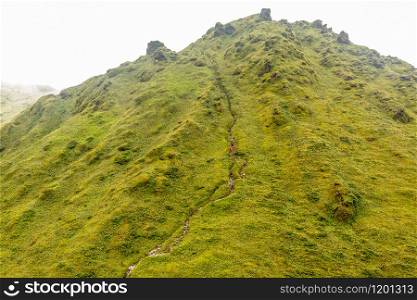 Mount Pelee green volcano hillside with hiking trail full of tourists, Martinique, French overseas department