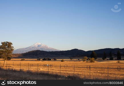 Mount Ranier, Washington and farmland field with irrigation