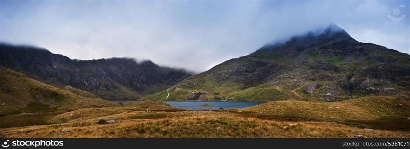 Mount Snowdon covered in low hanging cloud over Llyn Llydaw in Snowdonia National Park